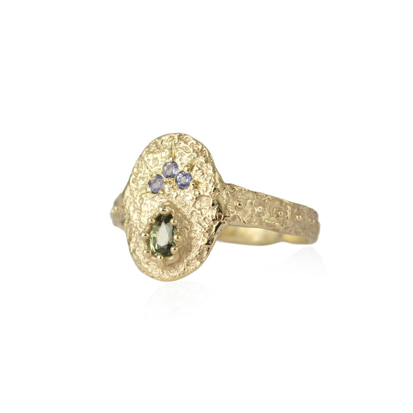 Pear-shaped green sapphire and tanzanite small shield ring